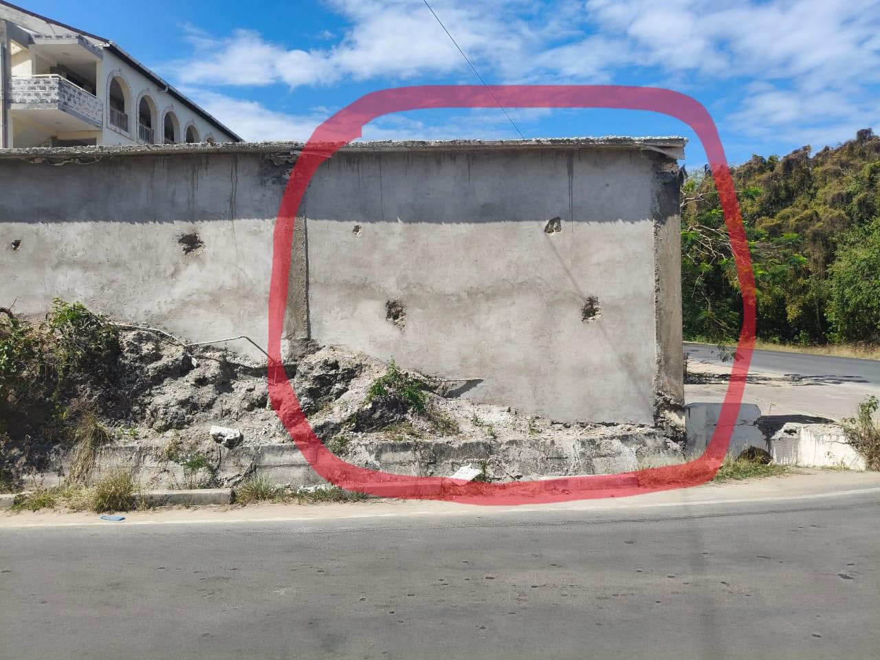 Boundary wall obstructing driver visibility at the Diani Beach Road junction, with the obstruction highlighted